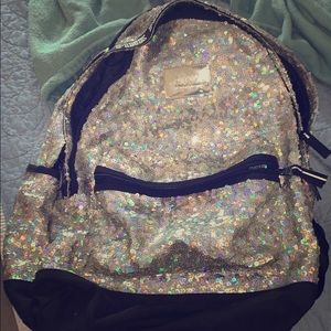 a silver holographic sequin backpack